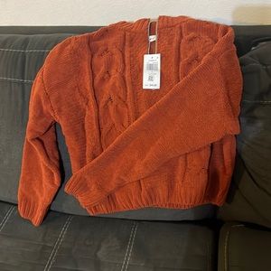Brand new burnt orange soft woman’s sweater.